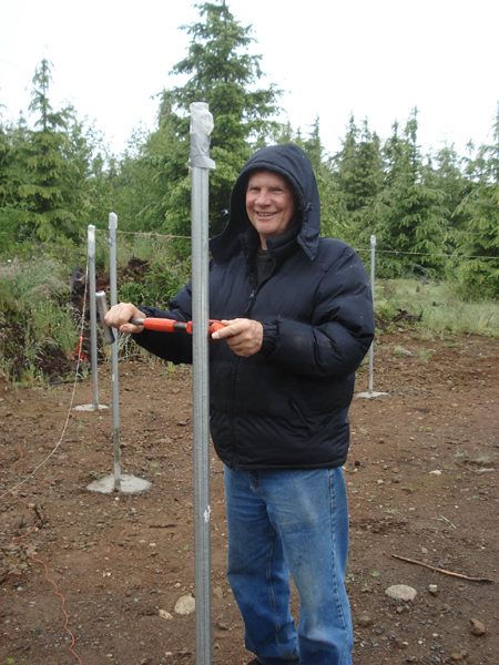 Mike Rogers cutting posts and pipes to length.